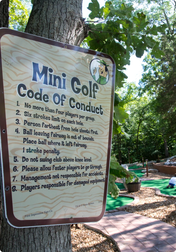 A sign displaying the mini golf code of conduct for players and visitors