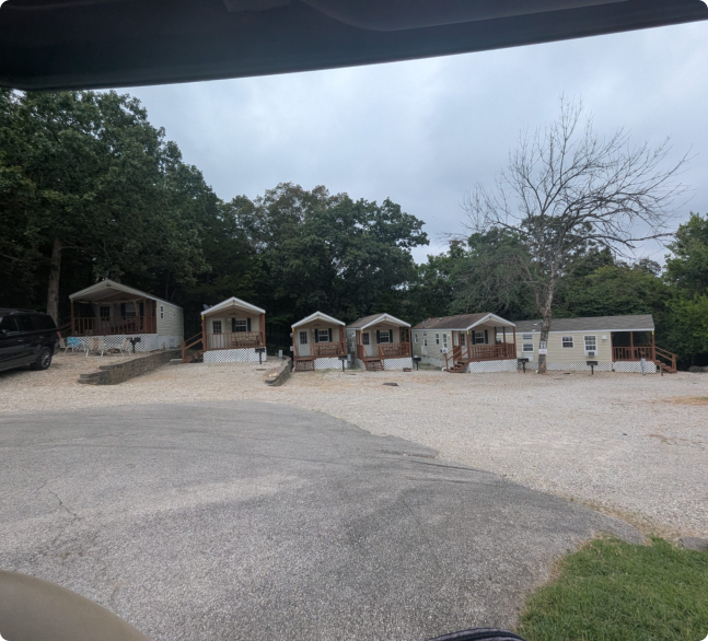 Scene from a car's back seat showing a mobile home park