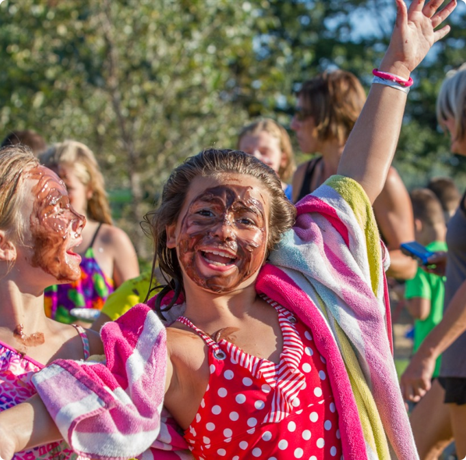 Two girls with chocolate-covered faces smile