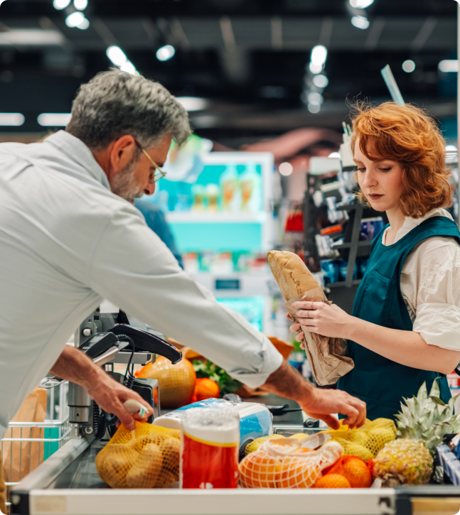 A man and woman are shopping together in a grocery store