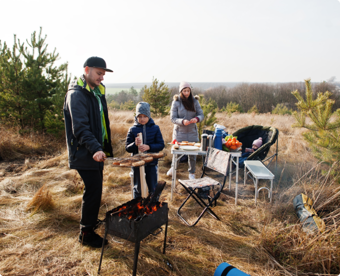 A man and a woman grilling food together outdoors