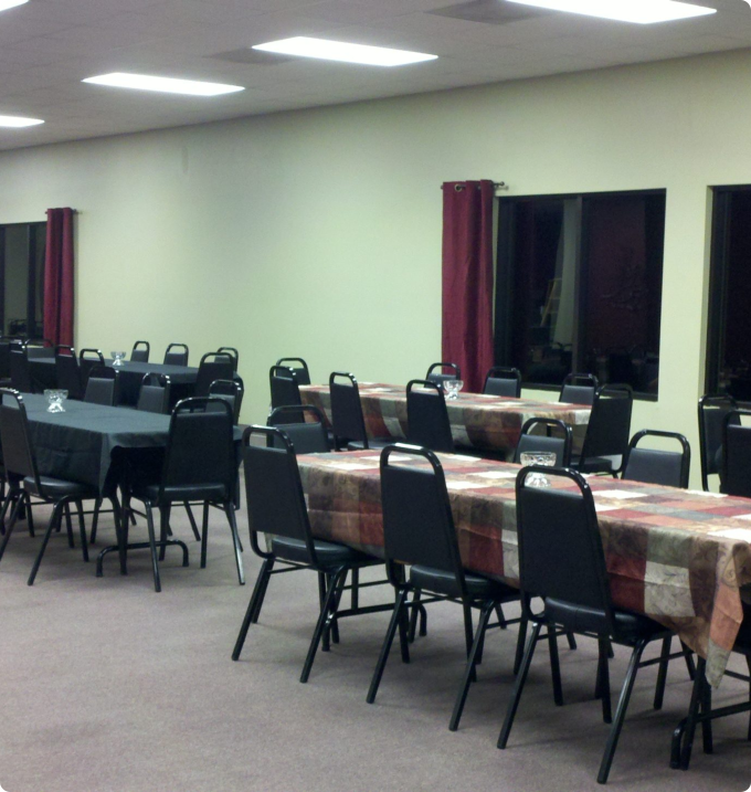 A spacious room filled with multiple tables and chairs