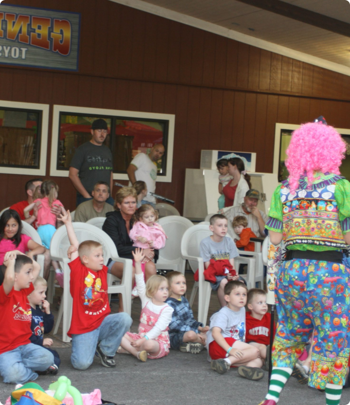A clown entertains a group of children