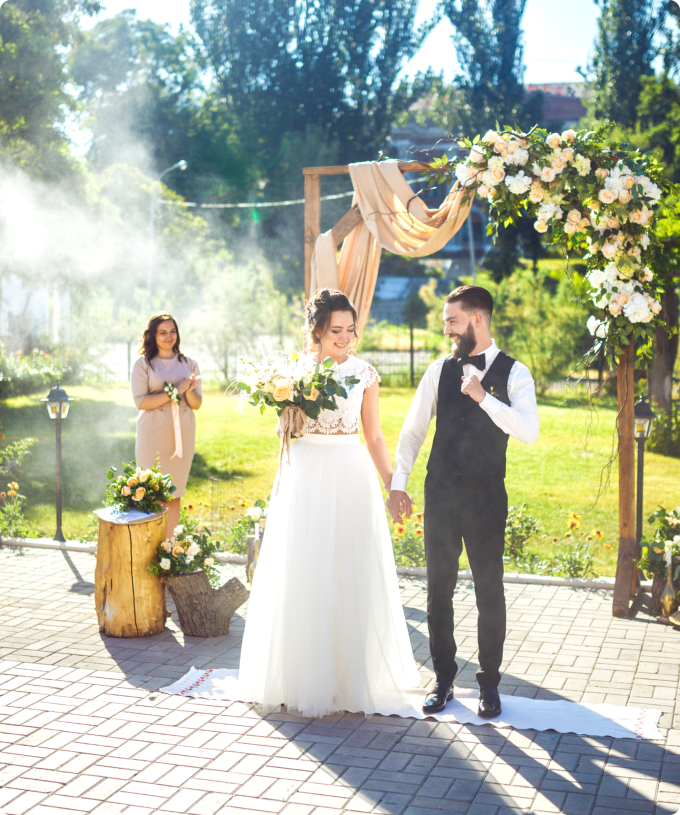 A newly married couple stands happily